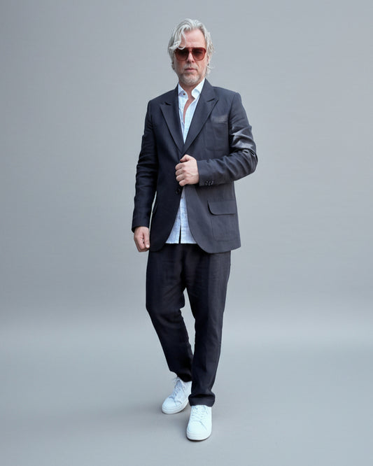 Model wearing Midnight black pants and a jacket in front of light grey backdrop?