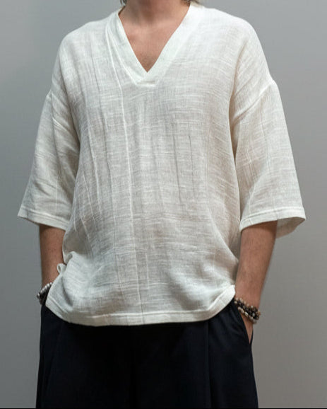 Person wearing a white shirt on a LIGJT GREY background