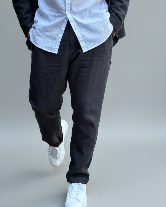 Model wearing Midnight black pants and a jacket in front of light grey backdrop?