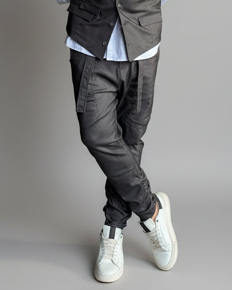MODEL STANDING ON A CONCRETE FLOOR IN FRONT OF A WHITE WALL