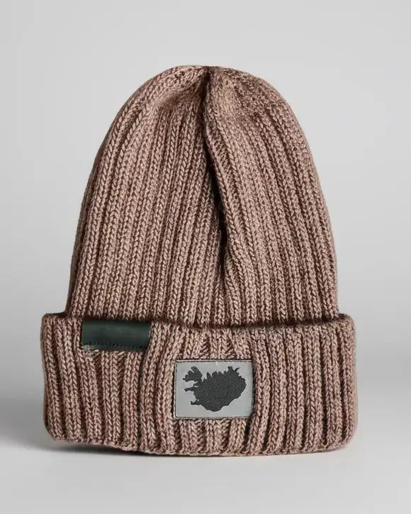 A brown beanie with a branded tag on the front showing the Reykjavik District logo on light grey backdrop

